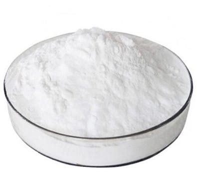 Fine white live yeast powder in a shallow dish, the physical form of a Saccharomyces cerevisiae feed additive